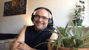 employee having a fun chat over zoom, as part of a patchwork of employees that were part of that conversation